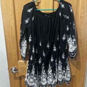 Black Embroidered dress with White Floral Detail. Can be off the shoulder too.